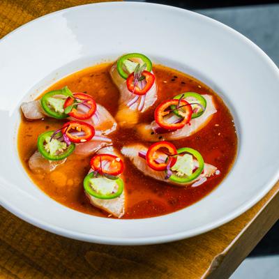 Hamachi crudo appetizer with tuna, ponzu sauce and jalapeño.
