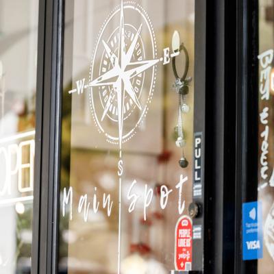Signage with a with compass design on the glass doors.