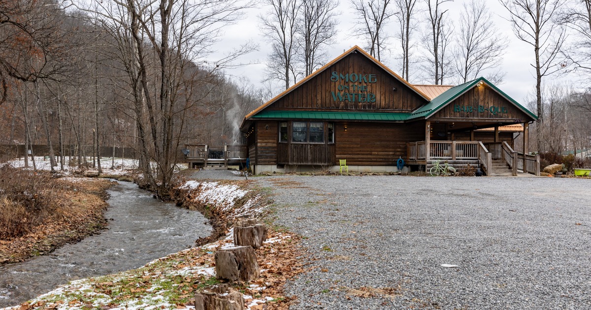 Exterior, front view to restaurant and river, parkin lot