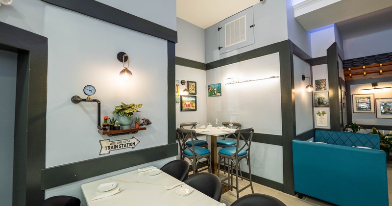 Modern dining area with tables, chairs, colorful art