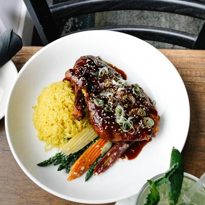 honey hoisin glazed roasted half duck jasmine rice, and vegetable.