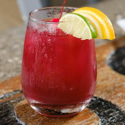 Emmet's Signature Sangria, red sangria garnished with lemon and lime slices.