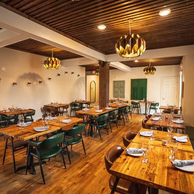 Interior, dining area with tableware on tables.