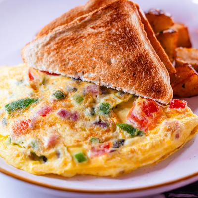 Ham and vegetable omelet served with toast and home fries.