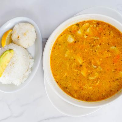 Chicken and vegetable Soup bowl  with rice on the side.