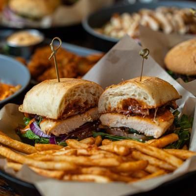 Chipotle Chicken Club Sandwich served with fries.