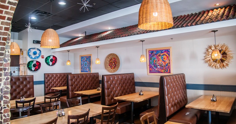 Nicely done interior dining area, tables, chairs, and upholstered booths