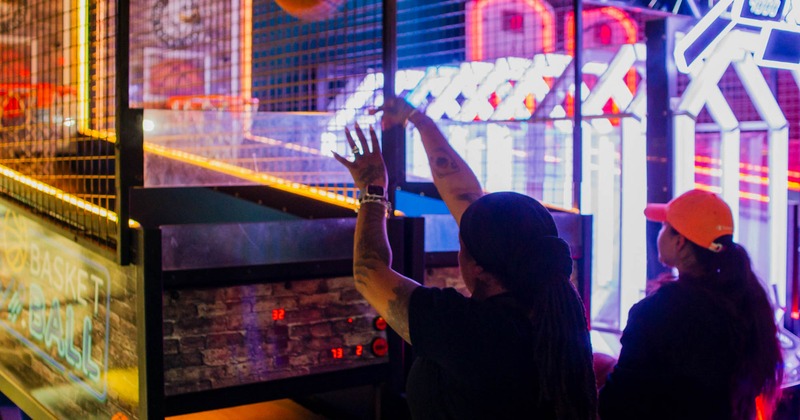 Customers playing arcade basketball