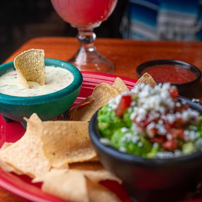 Jalapeño Cheese Dip and guacamole, served with tortilla chips.