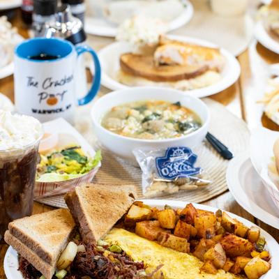 Assorted breakfast dishes served on a on table with a cup of coffee.