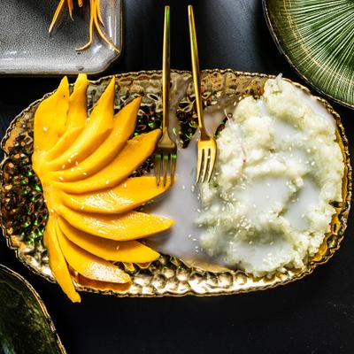 Mango sticky rice on a decorative gold platter.