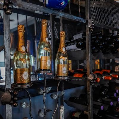 Hanging bottles and bottles on shelves behind the bar.
