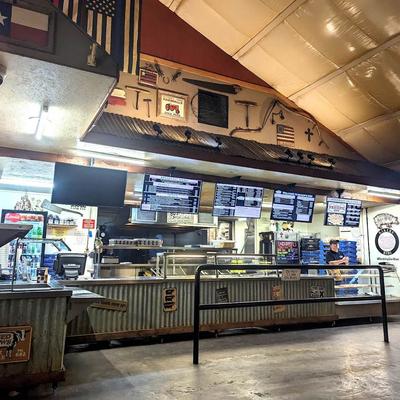 Interior, a counter service setup with several digital menu boards.