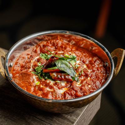 Goat curry prepared in a sauce of yoghurt and hot spices.