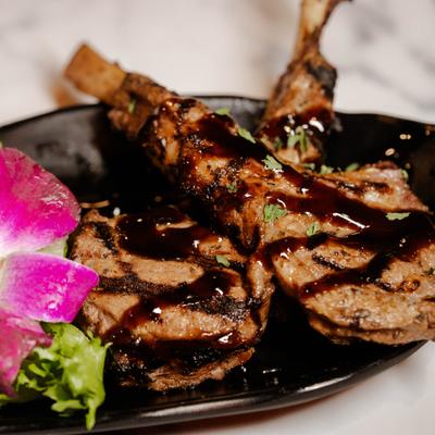 Lamb Lollipops drizzled with a balsamic glaze.