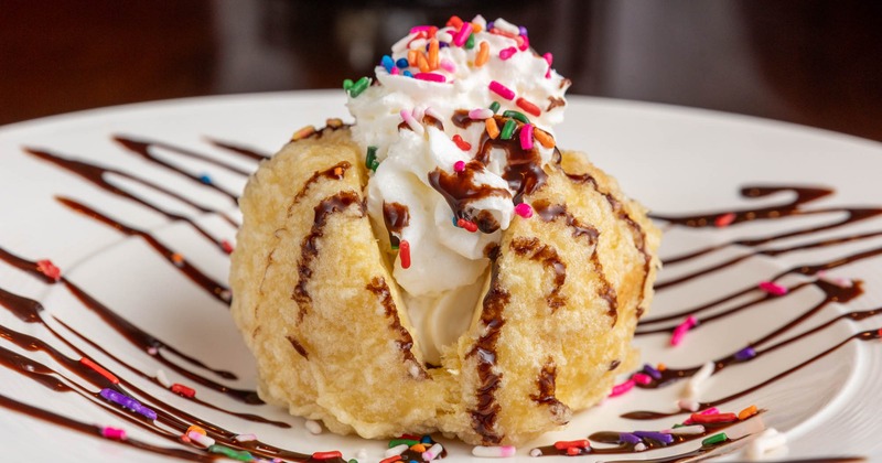 Fried ice cream with chocolate drizzle and sprinkles