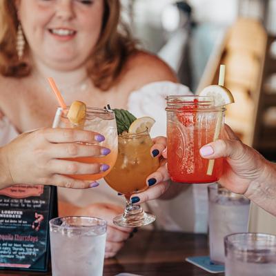 People making a toast with drinks.