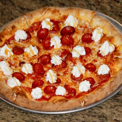 Sting Like a Bee Pizza with ricotta and hot honey.