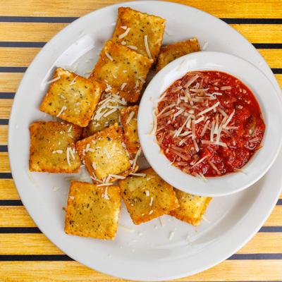 Toasted Ravioli topped with grated cheese and served with marinara sauce.