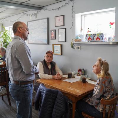 The owner talking to guests in the restaurant.