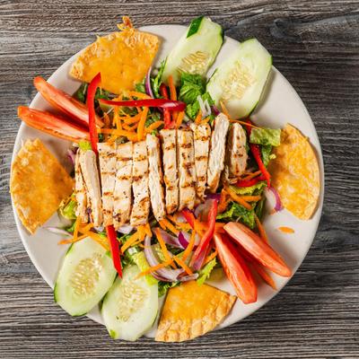 Fresh Garden Salad, with chicken, carrots, cucumber, peppers, onions, tomatoes, and chips.