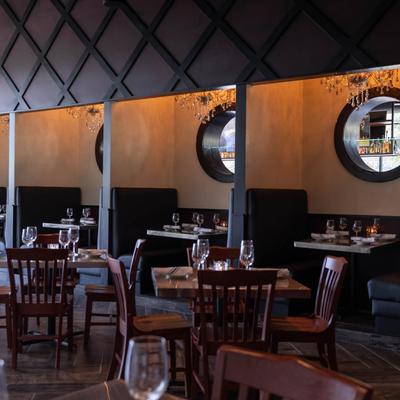 Dining area, tables and booths set with tableware.