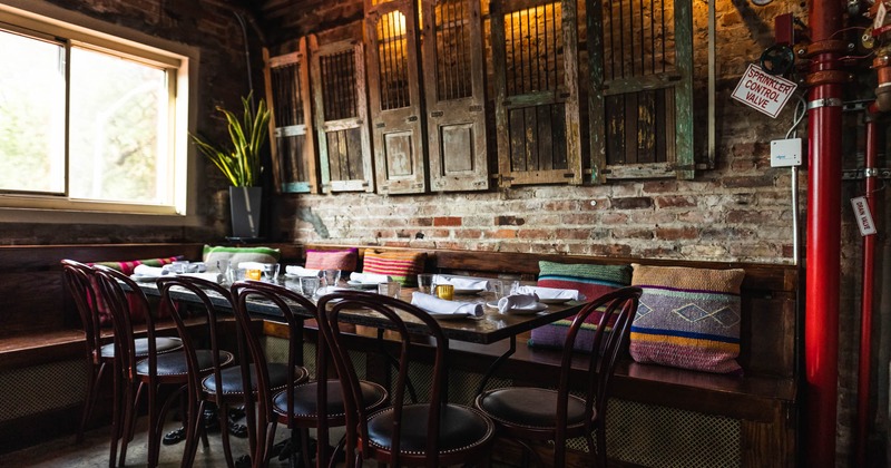 Interior, wooden bench, tables and chairs by the wall