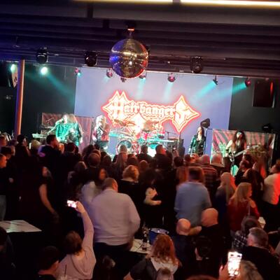Live band performing before a crowded audience.