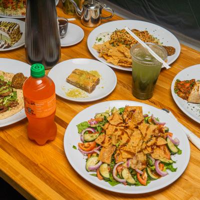 Assortment of dishes served on the table alongside drunks.