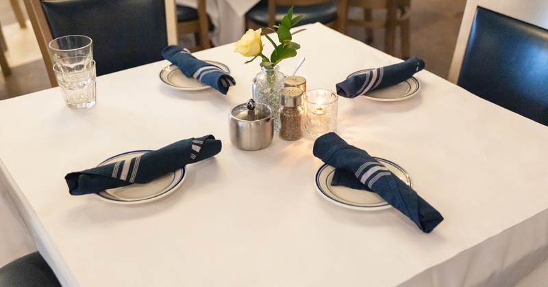 Dining table set for four guests close-up