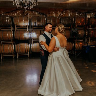 Wedding couple dancing in the Barrel Room at Next Chapter Winery.