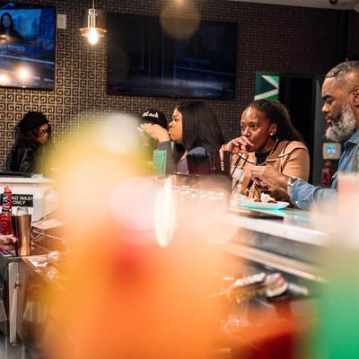 Customers sitting at the bar.