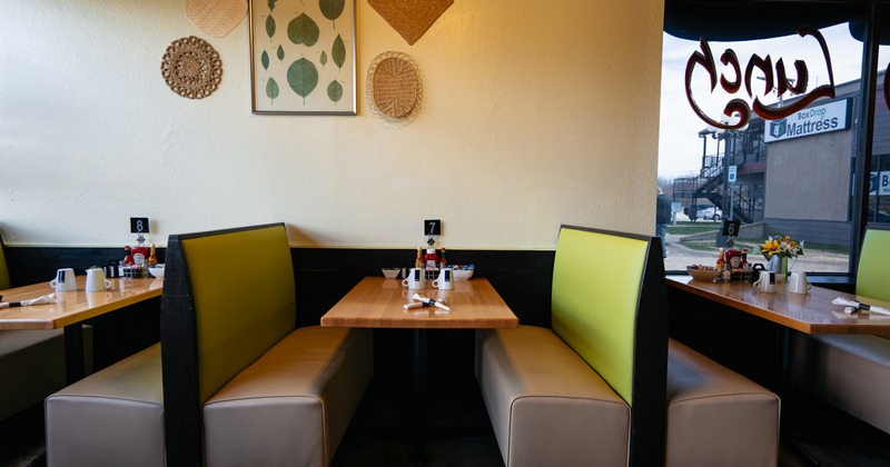 Interior, green seating booths by the window