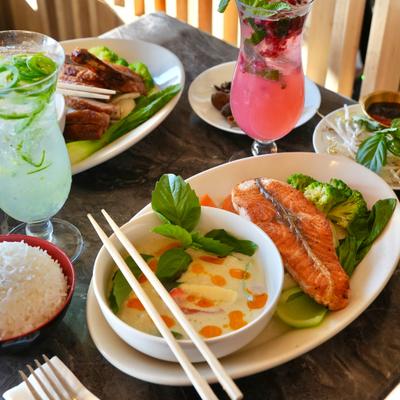 Salmon Clay Pot served on the table with drinks and other food items.