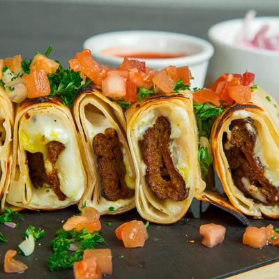 Ground beef served on bread with cheese as sushi roll.
