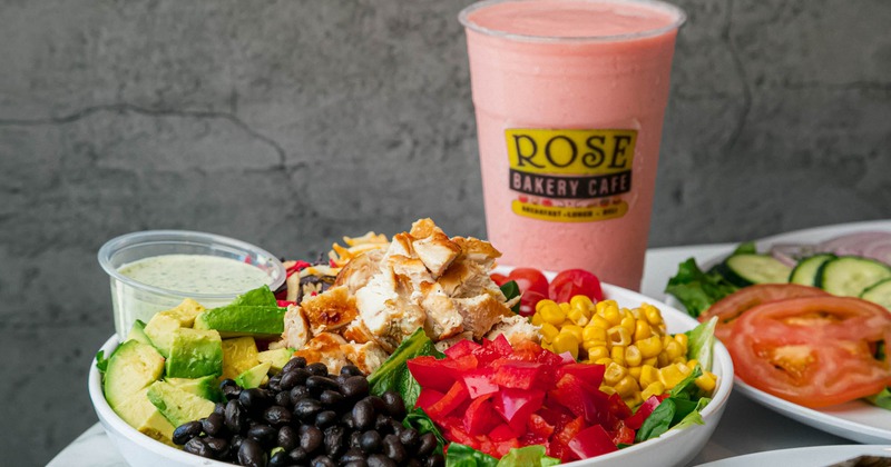 Pink smoothy in a branded plastic cup, Southwest Salad