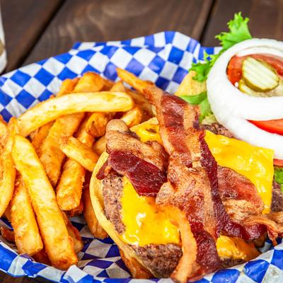 Bacon cheeseburger, with lettuce, tomato, onion, pickles, and fries.