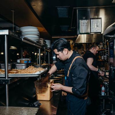 Kitchen staff preparing food in a bustling kitchen.