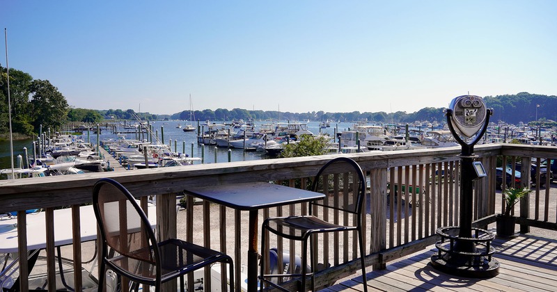 Exterior, terrace with table and two chairs, view of marine with boats