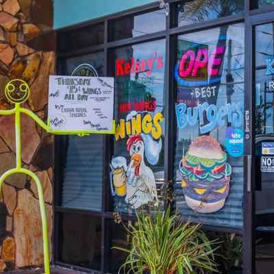 Kelsey’s storefront window with colorful hand-painted signs.