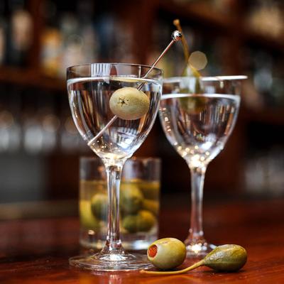 Couple of Martini cocktails, garnished with olives.