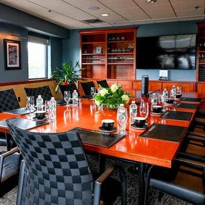 Modern boardroom with a table, coffee cups, and bottles of water.