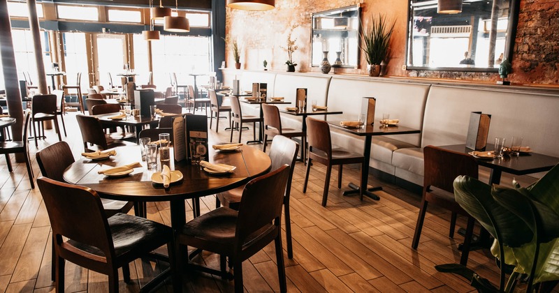 Interior, dining tables with tableware and seating