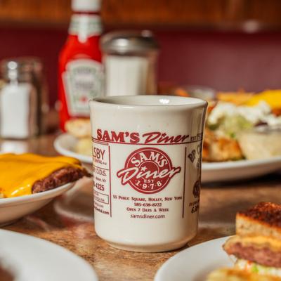 Coffee mug with Sam's Diner branding.