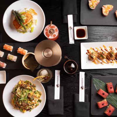 Overhead view of various dishes served with drinks and condiments.