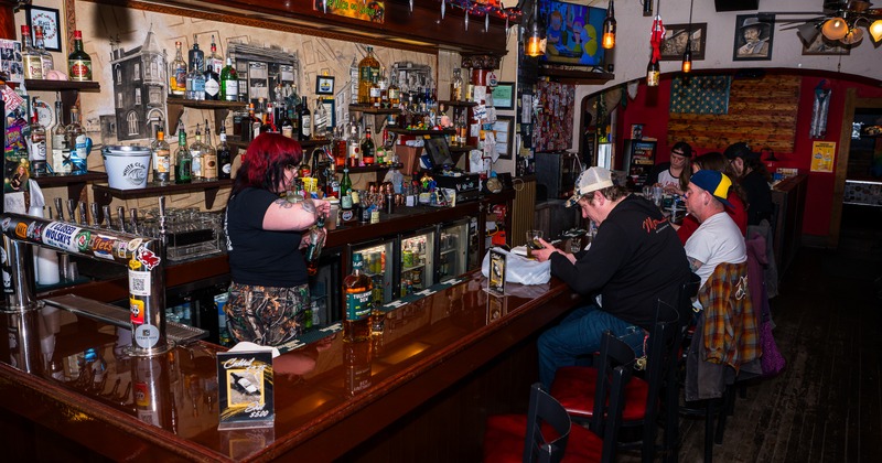 Interior, bar, stools, bartender, drink rack, guests