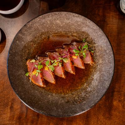 Tuna tataki with sesame dressing and microgreens.