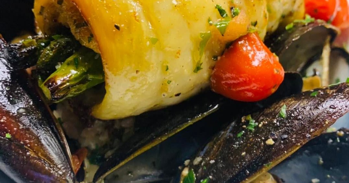 Rolled fillet of white fish with asparagus, cherry tomatoes and mussels