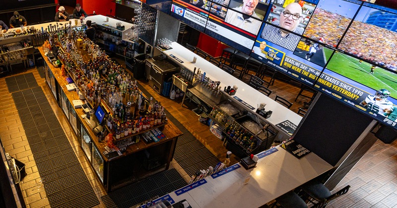 Central bar area with numereus TV screens, view from the upper flor
