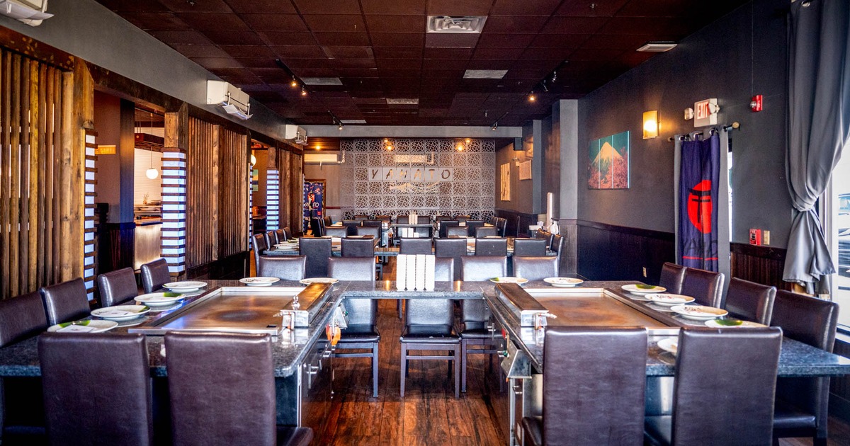 Interior, dining area, chairs and tables with hibachi grills, wooden room dividers